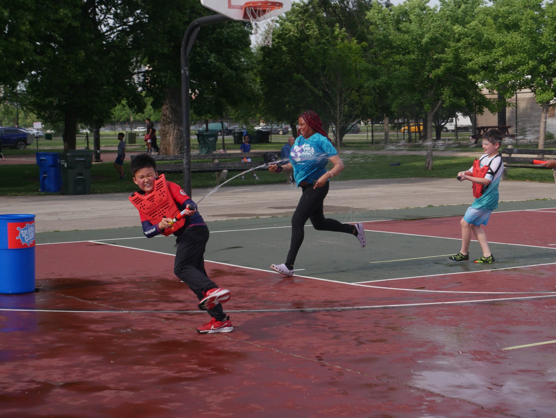 Kids dodging water blasts at a Splash Clash event
